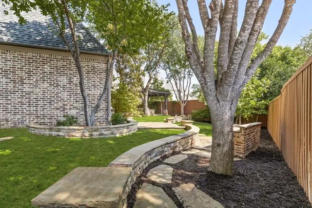a view of a backyard with large tree