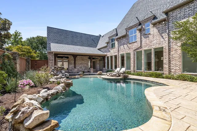 a front view of a house with swimming pool and outdoor seating