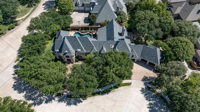 an aerial view of house with yard and outdoor seating