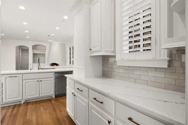 a kitchen with granite countertop a sink and cabinets