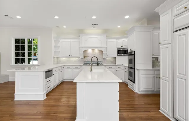 a kitchen with kitchen island a sink stainless steel appliances and window