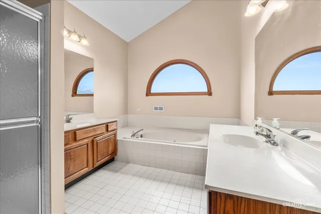 a bathroom with a bathtub a sink and a window