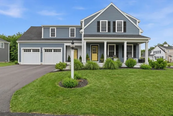 a front view of a house with a yard and porch
