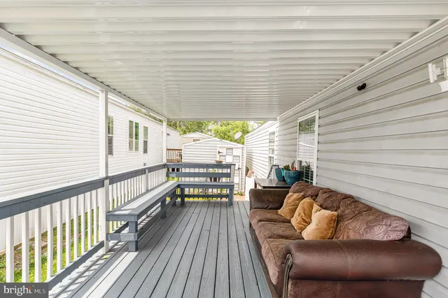 a balcony with wooden floor and furniture