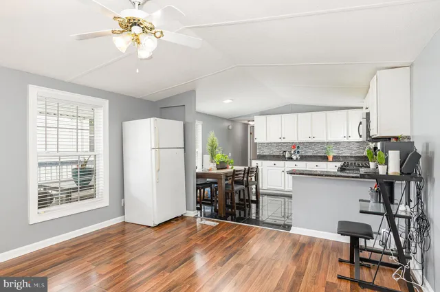 a kitchen with stainless steel appliances a refrigerator and a stove top oven