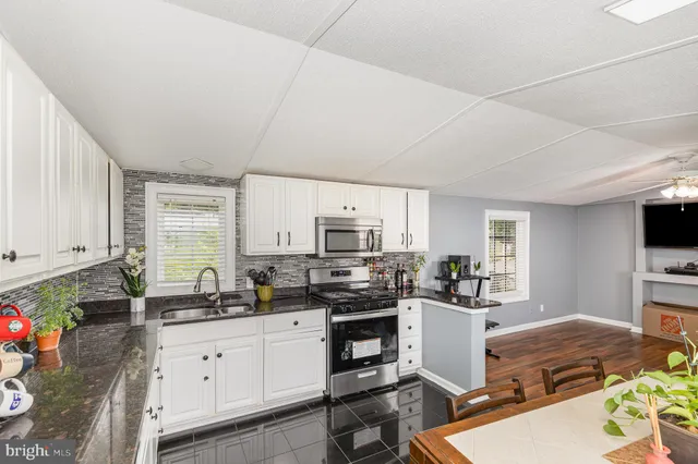 a kitchen with a sink stove top oven and cabinets