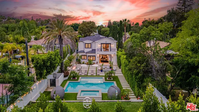 a front view of a house with a garden and plants