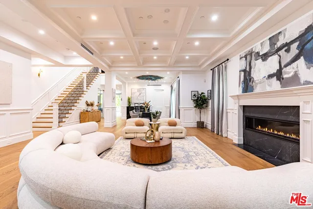 a living room with furniture and view of kitchen