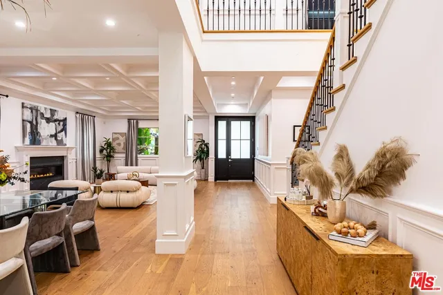 a dining room with furniture a chandelier and wooden floor