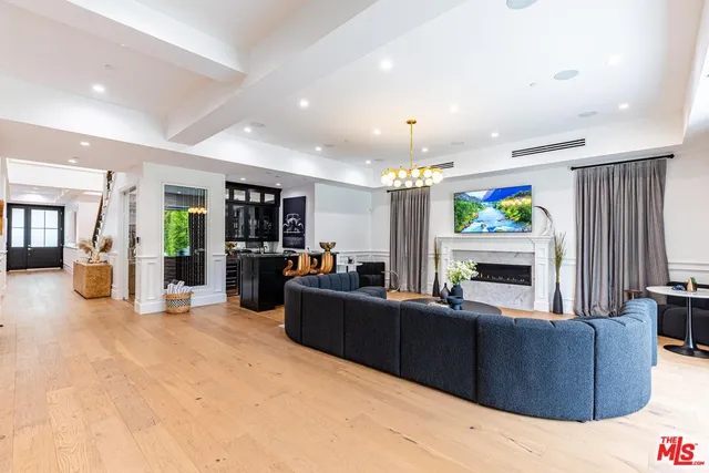 a living room with furniture a fireplace and a large window