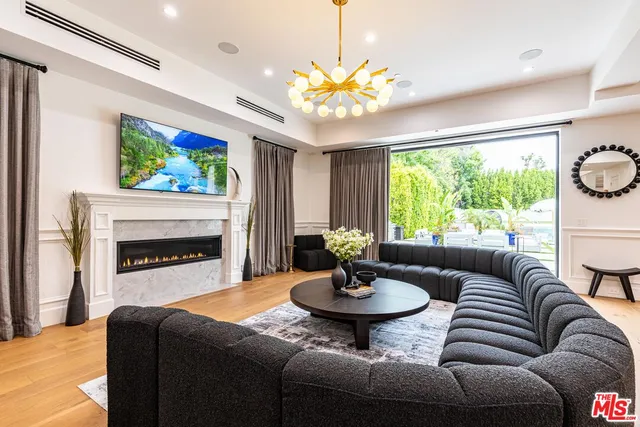 a kitchen with stainless steel appliances granite countertop a sink and a refrigerator