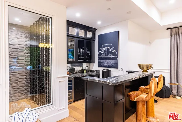 a kitchen with a table chairs refrigerator and cabinets