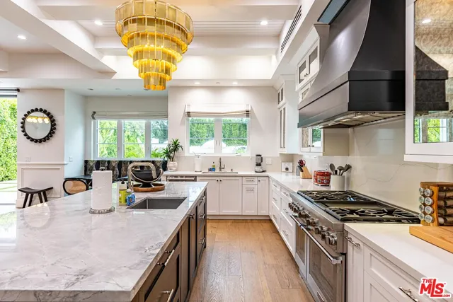 a living room with kitchen island furniture and a chandelier
