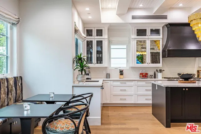 a large bedroom with a large bed and a chandelier