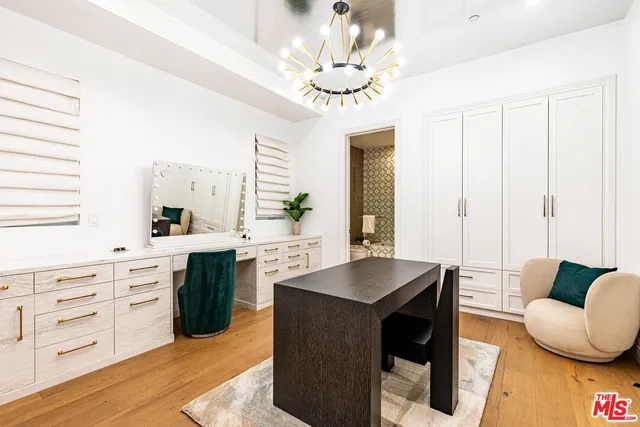 a view of a hallway with wooden floor and windows