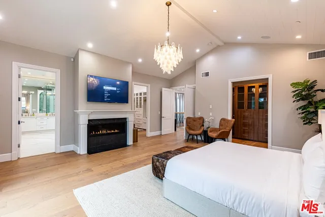 a bathroom with a sink a toilet a mirror a bathtub and shower