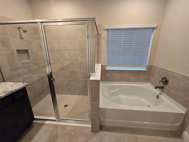 a bathroom with a tub and shower