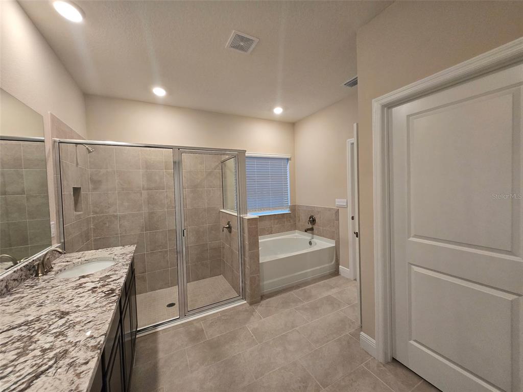 6008 Southwest 46th Drive Gainesville, FL 32608 - Photo 19 of 56 a bathroom with a tub and shower