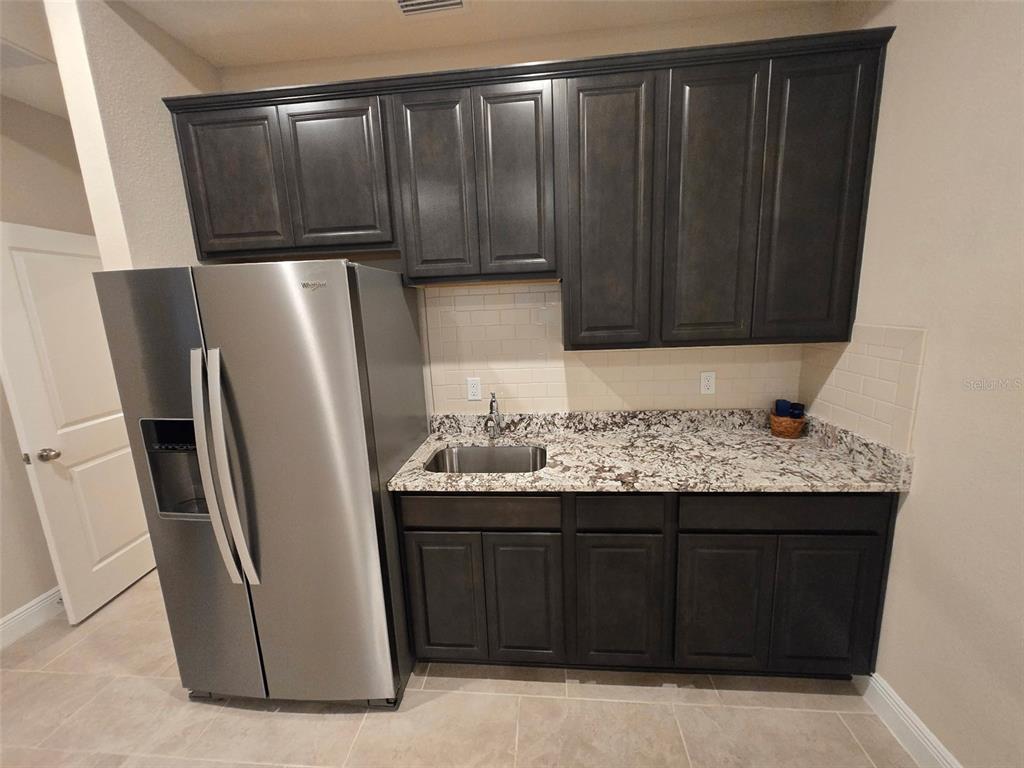 6008 Southwest 46th Drive Gainesville, FL 32608 - Photo 37 of 56 a kitchen with a refrigerator and a stove