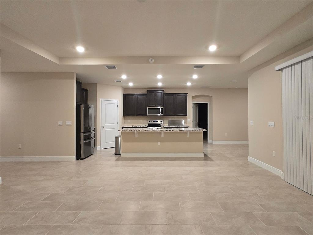 6008 Southwest 46th Drive Gainesville, FL 32608 - Photo 4 of 56 a view of kitchen with microwave and refrigerator