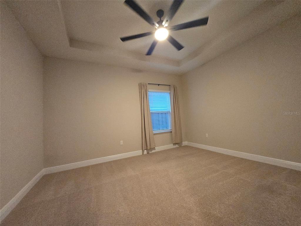 6008 Southwest 46th Drive Gainesville, FL 32608 - Photo 41 of 56 an empty room with a window and a ceiling fan