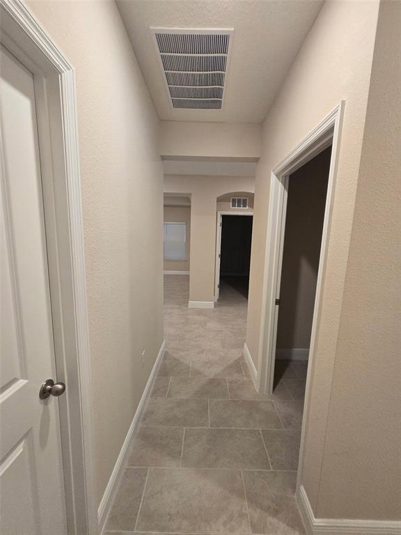 6008 Southwest 46th Drive Gainesville, FL 32608 - Photo 45 of 56 a view of hallway with stairs and a white door