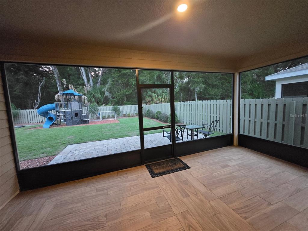 6008 Southwest 46th Drive Gainesville, FL 32608 - Photo 52 of 56 a view of a porch with a floor to ceiling window and a yard
