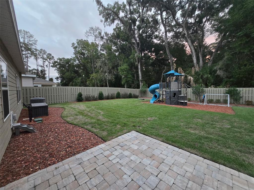 6008 Southwest 46th Drive Gainesville, FL 32608 - Photo 55 of 56 a view of a park with large trees and a wooden fence