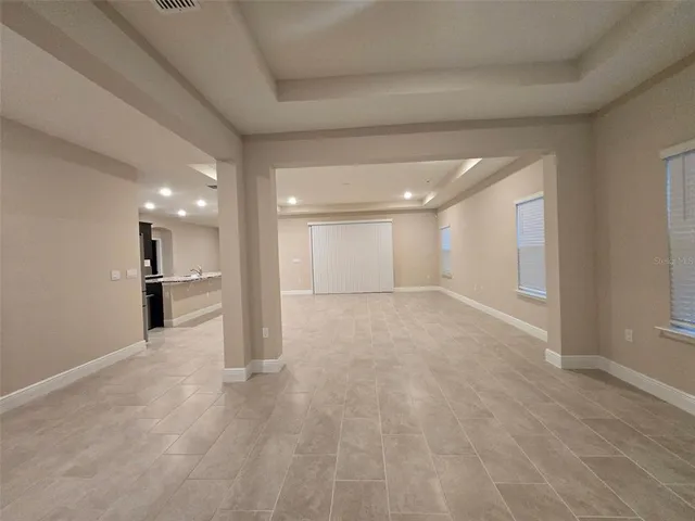a view of a big room with wooden cabinet and windows