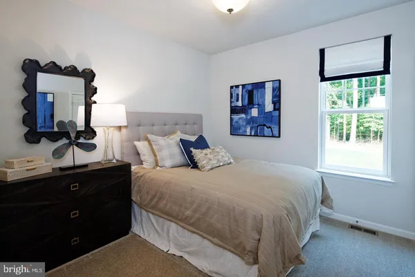 a room with a wooden floor and a mirror