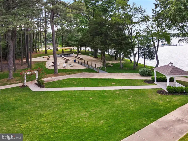 an aerial view of a house with a yard basket ball court and outdoor seating