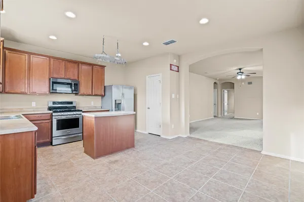 a large kitchen with cabinets and stainless steel appliances