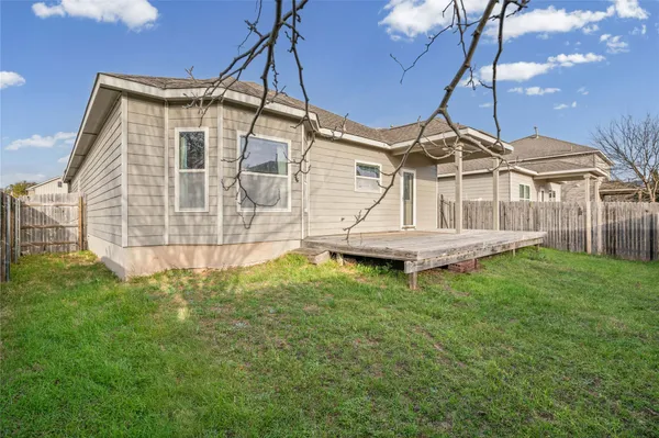 a white house with a big yard and large tree
