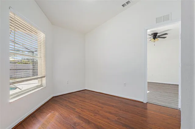 wooden floor in an empty room with a window