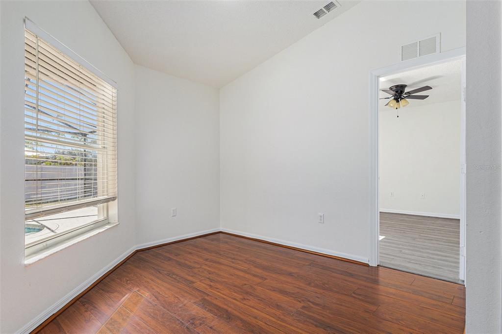 7182 Summit Drive Winter Haven, FL 33884 - Photo 17 of 27 wooden floor in an empty room with a window