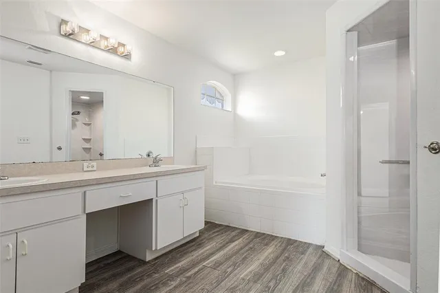 a bathroom with a tub sink and mirror