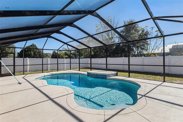 a view of a backyard with swimming pool