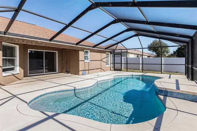 a swimming pool with outdoor seating and yard