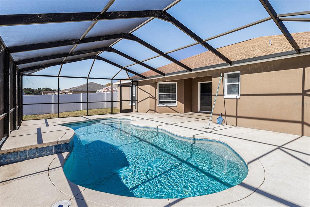 7182 Summit Drive Winter Haven, FL 33884 - Photo 26 of 27 a swimming pool with outdoor seating