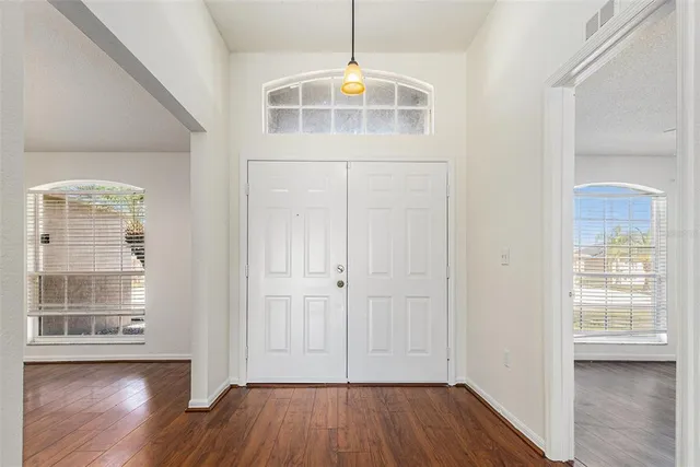 an empty room with wooden floor and a window