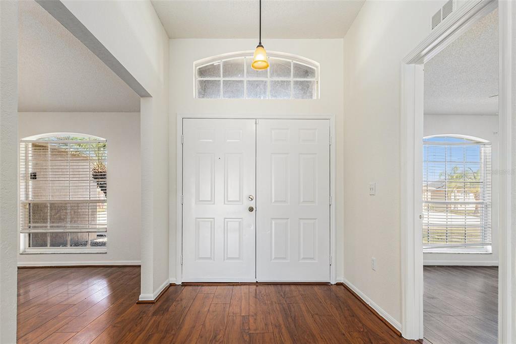 7182 Summit Drive Winter Haven, FL 33884 - Photo 3 of 27 an empty room with wooden floor and a window