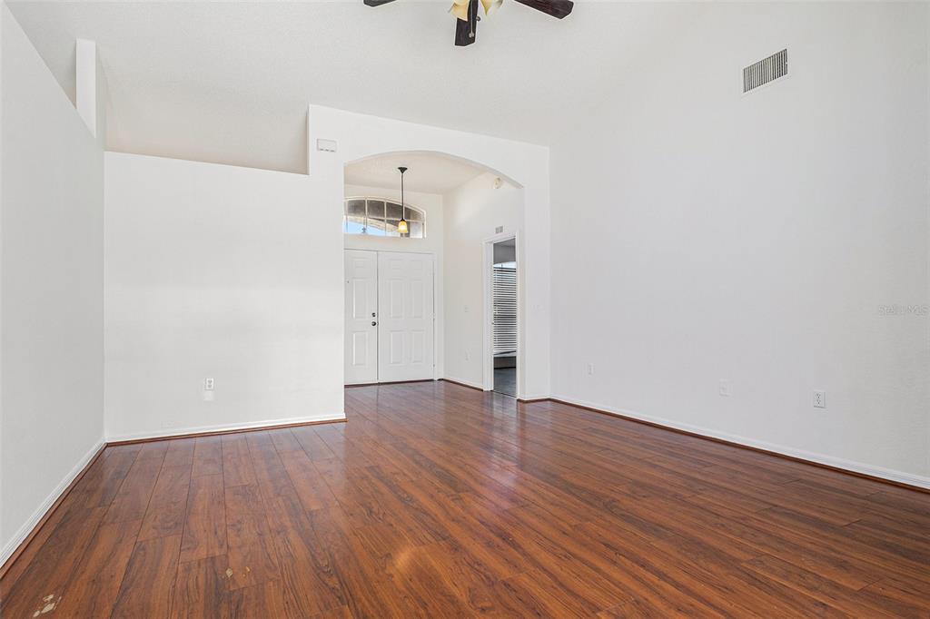 7182 Summit Drive Winter Haven, FL 33884 - Photo 5 of 27 a view of an empty room with wooden floor