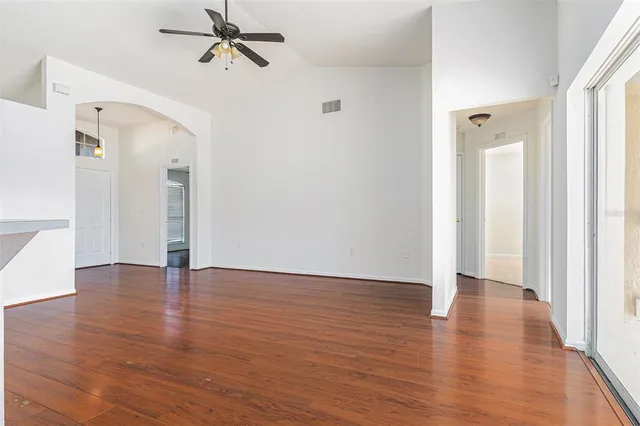 a view of an empty room with wooden floor