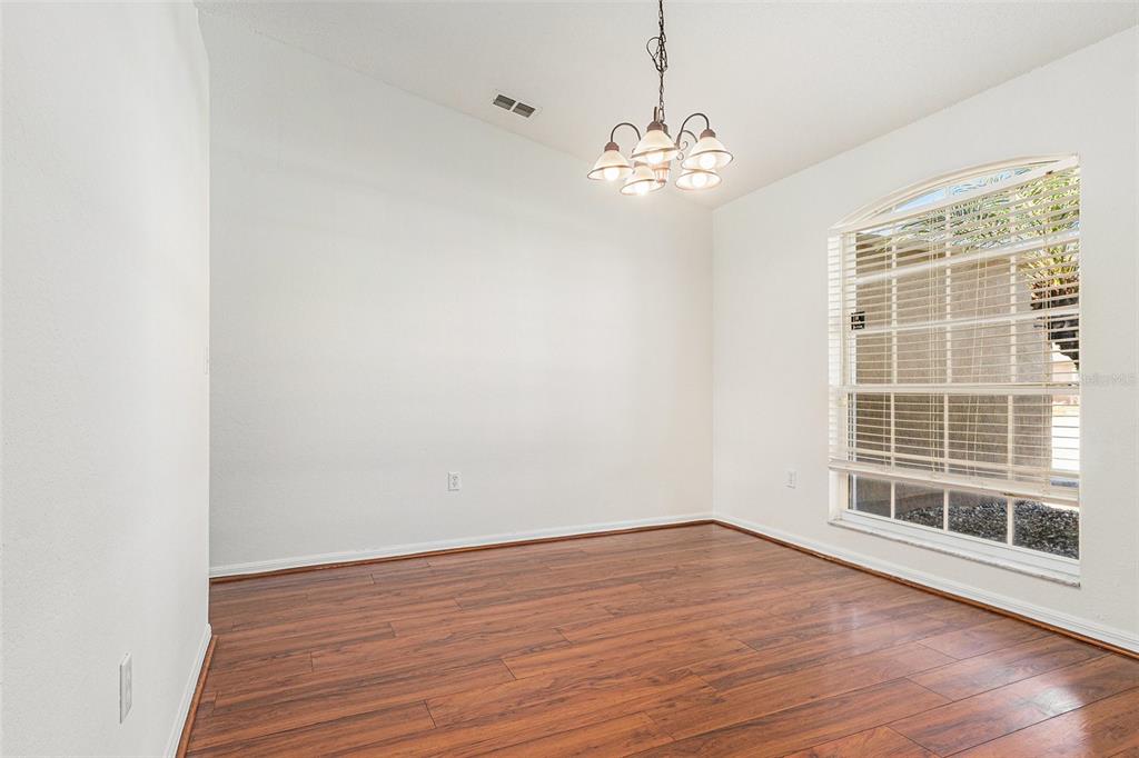7182 Summit Drive Winter Haven, FL 33884 - Photo 8 of 27 a view of empty room with wooden floor and fan