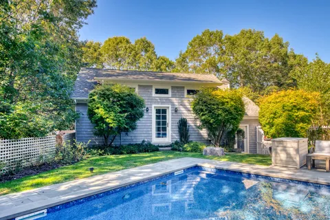 a view of a house with a yard and plants