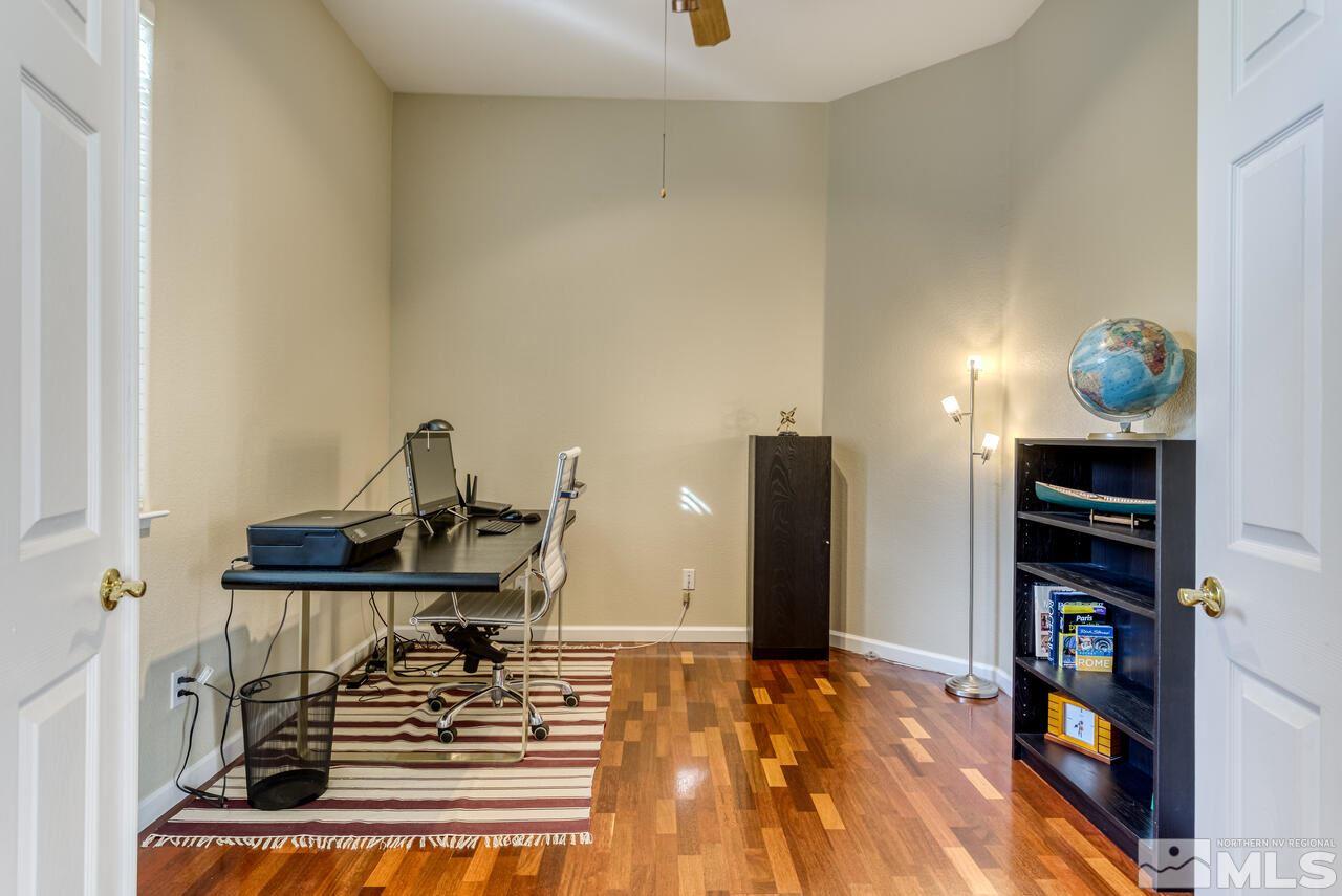 3755 Bridge Creek Court Reno, NV 89519 - Photo 12 of 40 a view of a workspace with furniture and a book shelf