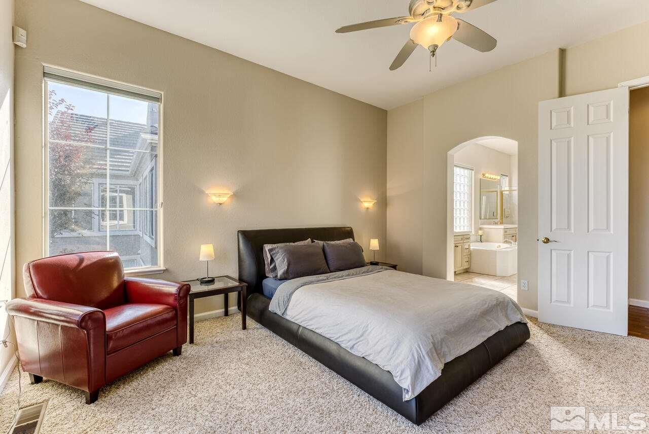 3755 Bridge Creek Court Reno, NV 89519 - Photo 20 of 40 a bedroom with a bed couch and window