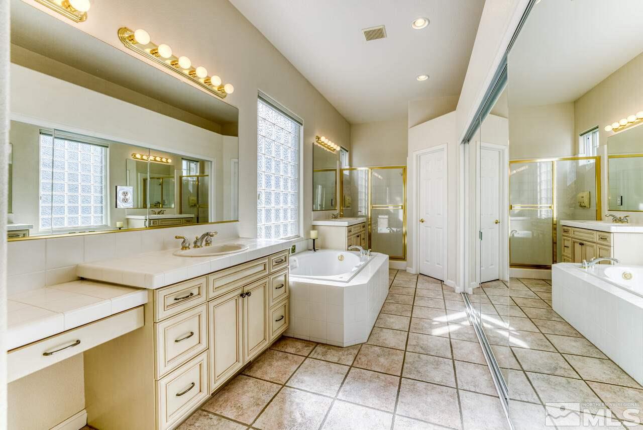 3755 Bridge Creek Court Reno, NV 89519 - Photo 21 of 40 a spacious bathroom with a double vanity sink a mirror and a bathtub