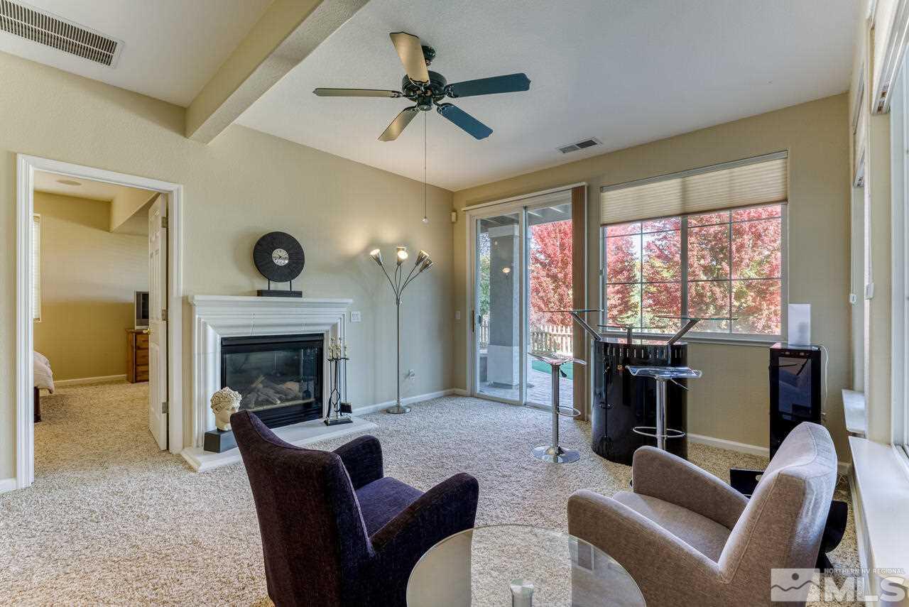 3755 Bridge Creek Court Reno, NV 89519 - Photo 25 of 40 a living room with furniture a fireplace and a large window