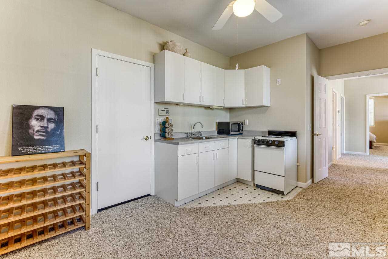 3755 Bridge Creek Court Reno, NV 89519 - Photo 28 of 40 a kitchen with white cabinets and white appliances
